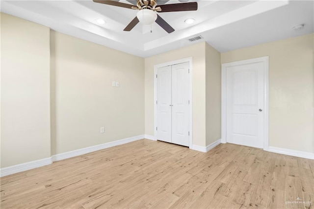 2601 Moreno Sr, Edinburg, TX 78541 - unfurnished bedroom with a raised ceiling, light wood finished floors, recessed lighting, baseboards, and a ceiling fan