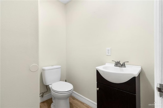 2601 Moreno Sr, Edinburg, TX 78541 - bathroom with vanity, wood finished floors, toilet, and baseboards