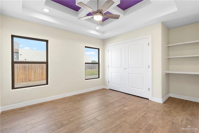 2601 Moreno Sr, Edinburg, TX 78541 - unfurnished bedroom featuring a raised ceiling, wood-type flooring, multiple windows, baseboards, and recessed lighting