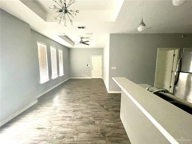 hall featuring a notable chandelier, dark hardwood / wood-style flooring, and sink