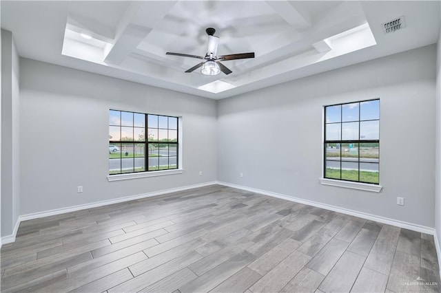 612 Spruce St, Rio Grande City, TX 78582 - spare room with a tray ceiling, ceiling fan, plenty of natural light, and wood finished floors