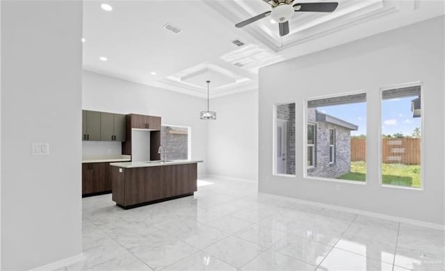 kitchen featuring pendant lighting, a center island with sink, sink, ceiling fan, and dark brown cabinets