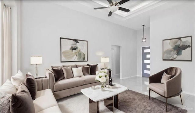 living room featuring a high ceiling and ceiling fan