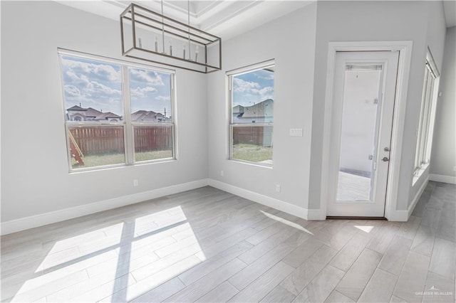 unfurnished dining area with light wood-type flooring