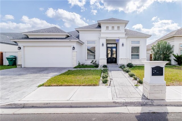 view of front of house featuring a garage, a front lawn, and french doors