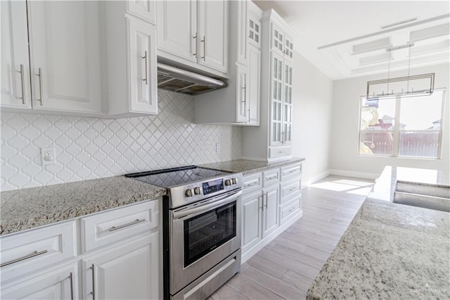 kitchen featuring pendant lighting, light hardwood / wood-style flooring, white cabinets, stainless steel electric range oven, and decorative backsplash