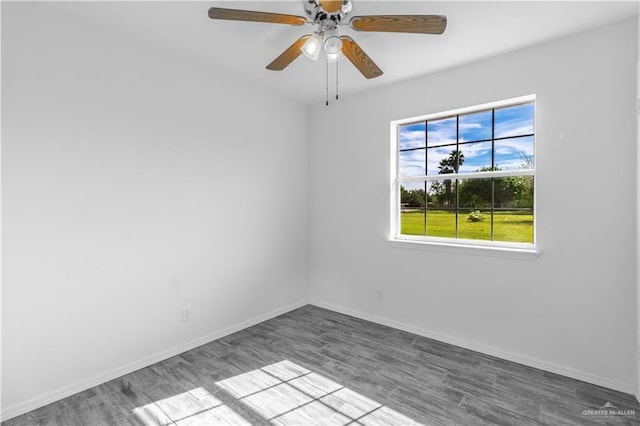 empty room featuring baseboards, wood finished floors, and ceiling fan