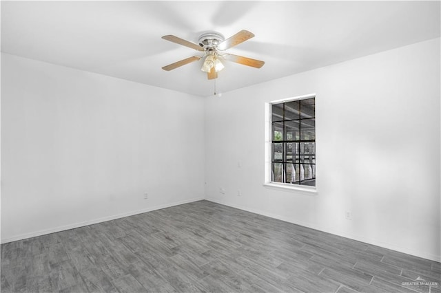unfurnished room with wood finished floors, a ceiling fan, and baseboards