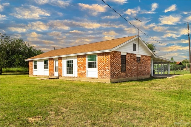 exterior space with a front lawn and brick siding