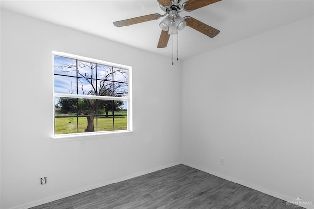 unfurnished room with baseboards, a wealth of natural light, ceiling fan, and dark wood-style flooring