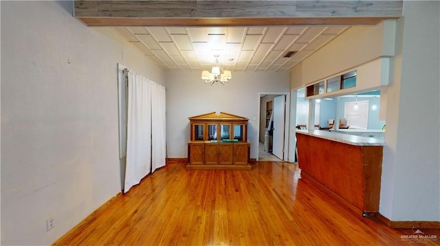 interior space with hanging light fixtures, light hardwood / wood-style floors, and a notable chandelier