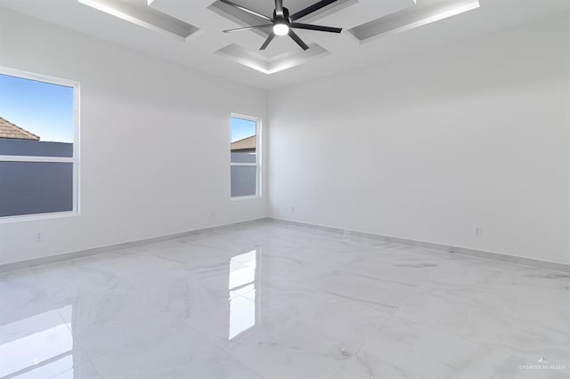 empty room with marble finish floor, coffered ceiling, ceiling fan, and baseboards