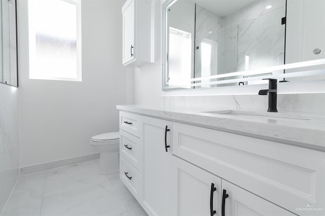 bathroom featuring toilet, vanity, baseboards, marble finish floor, and a marble finish shower