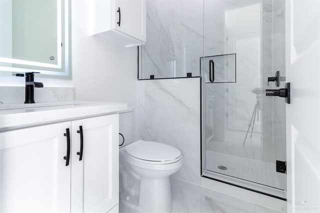 full bathroom featuring toilet, vanity, and a marble finish shower