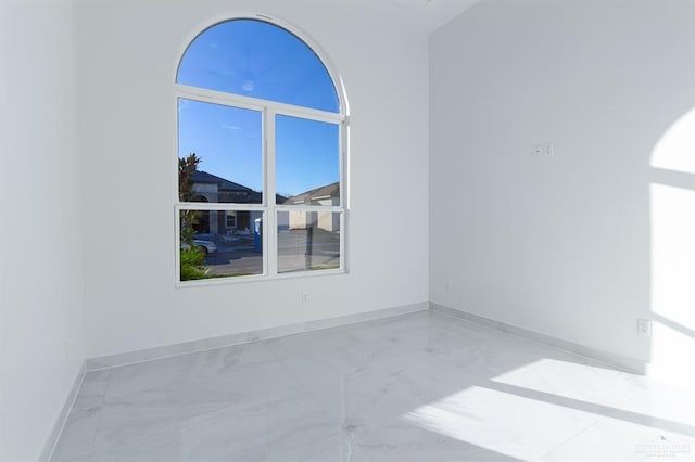 spare room featuring baseboards