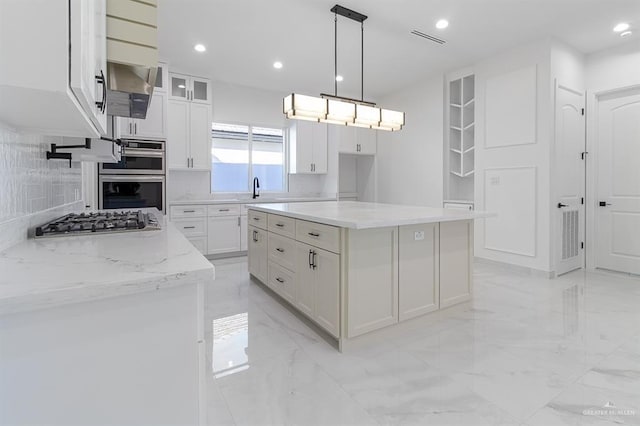 kitchen with marble finish floor, white cabinetry, appliances with stainless steel finishes, and recessed lighting