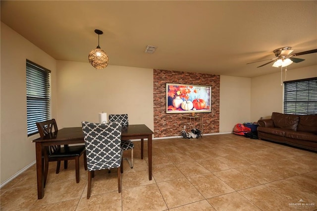 dining space with ceiling fan and light tile patterned floors