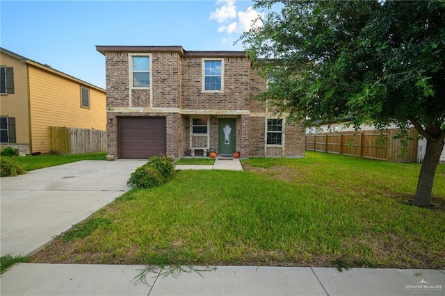 view of front of property featuring a garage and a front lawn