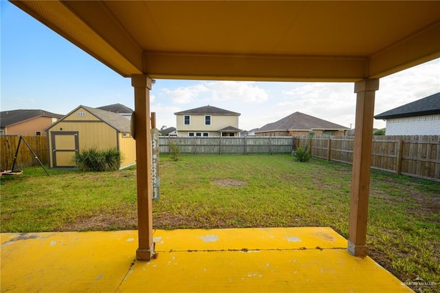 view of yard with a patio area and a storage shed