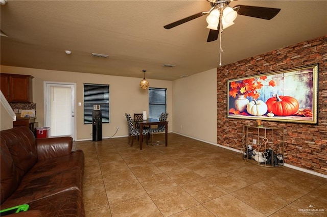 tiled living room with ceiling fan