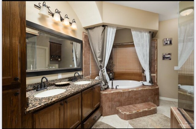 1336 Loretta Lynn Dr, Edinburg, TX 78541 - bathroom with tiled tub, double vanity, and tile patterned floors