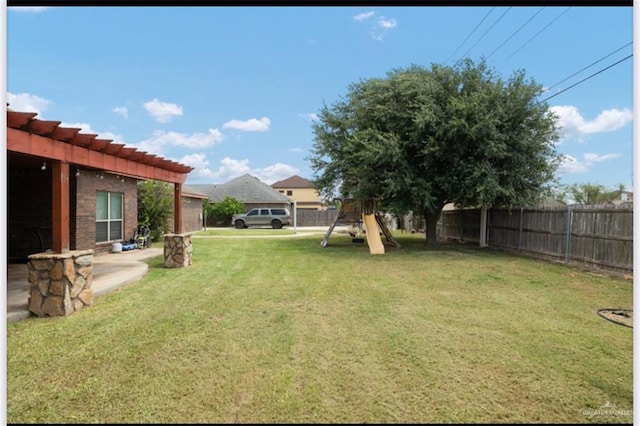 1336 Loretta Lynn Dr, Edinburg, TX 78541 - fenced backyard featuring a playground, a pergola, and a patio area