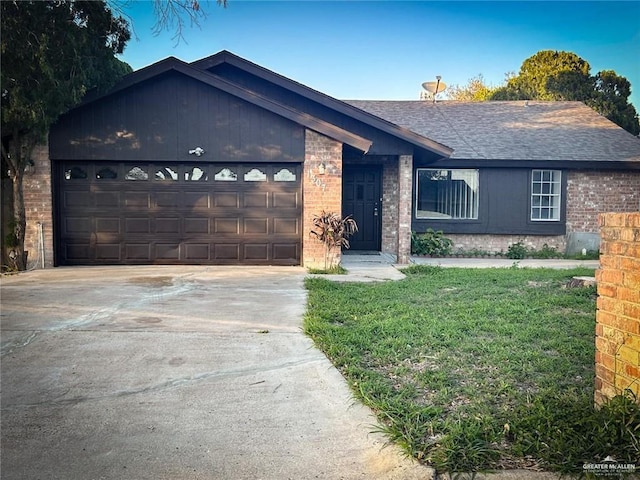 ranch-style house featuring a front yard and a garage