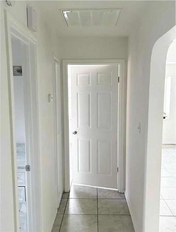 hallway featuring light tile patterned floors