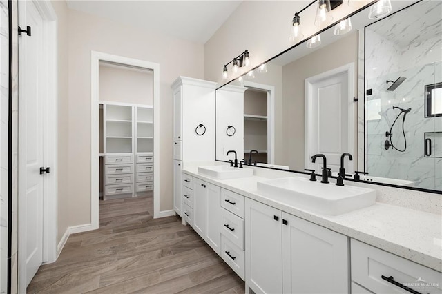 bathroom with vanity, an enclosed shower, and hardwood / wood-style flooring