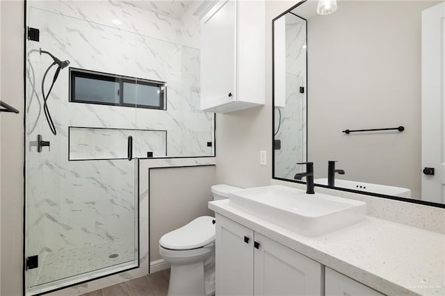 bathroom featuring vanity, wood-type flooring, an enclosed shower, and toilet