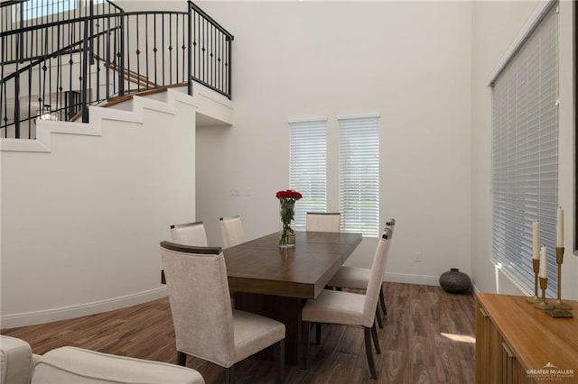 3101 E Iverson Ave, Edinburg, TX 78542 - dining area with baseboards, dark wood-type flooring, a towering ceiling, plenty of natural light, and stairs