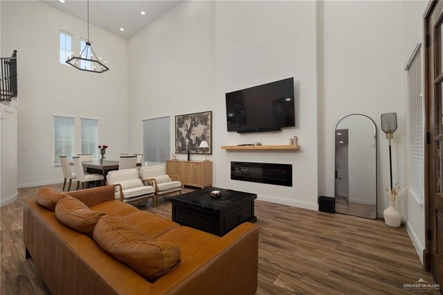 3101 E Iverson Ave, Edinburg, TX 78542 - living area featuring high vaulted ceiling, wood finished floors, baseboards, recessed lighting, and a chandelier