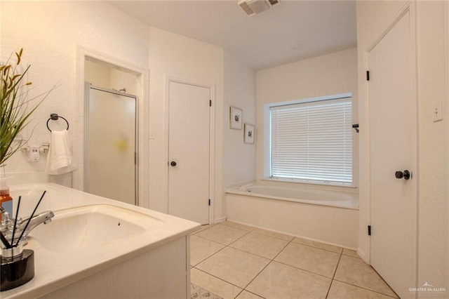 bathroom with plus walk in shower, vanity, and tile patterned floors