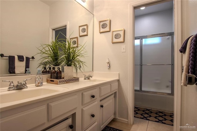 bathroom featuring tile patterned floors, vanity, and bath / shower combo with glass door