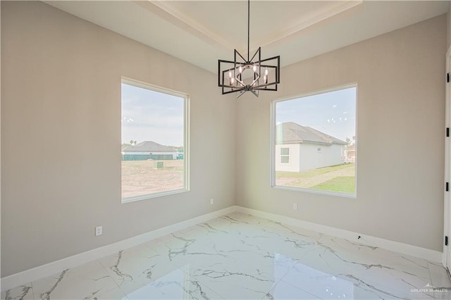 8038 N 51st St, Mcallen, TX 78504 - empty room featuring a chandelier, marble finish flooring, and a tray ceiling