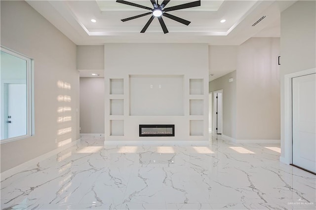 8038 N 51st St, Mcallen, TX 78504 - unfurnished living room featuring ceiling fan, a raised ceiling, a glass covered fireplace, recessed lighting, and marble finish flooring