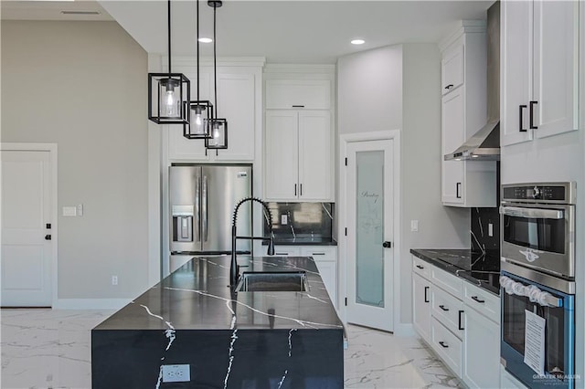 8038 N 51st St, Mcallen, TX 78504 - kitchen with stainless steel appliances, light marble finish floors, wall chimney range hood, tasteful backsplash, and decorative light fixtures