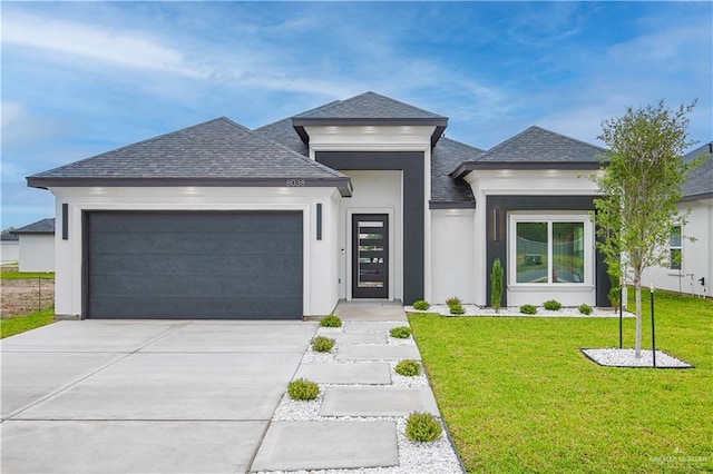 8038 N 51st St, Mcallen, TX 78504 - view of front facade featuring a shingled roof, an attached garage, a front lawn, concrete driveway, and stucco siding