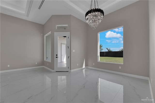 unfurnished room featuring plenty of natural light and an inviting chandelier