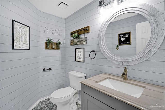 bathroom featuring tile patterned floors, vanity, and toilet