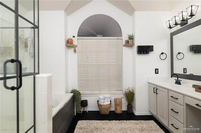 bathroom with vanity and shower with separate bathtub