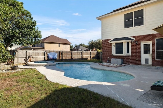 view of swimming pool featuring an in ground hot tub and a patio area