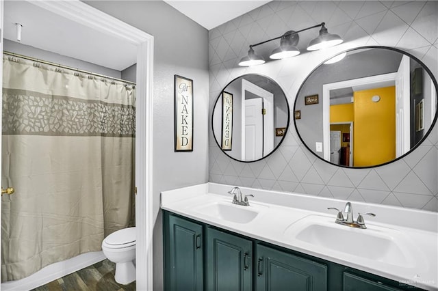 bathroom featuring vanity, hardwood / wood-style flooring, a shower with shower curtain, toilet, and tile walls