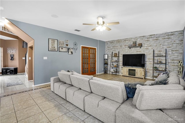 tiled living room featuring ceiling fan