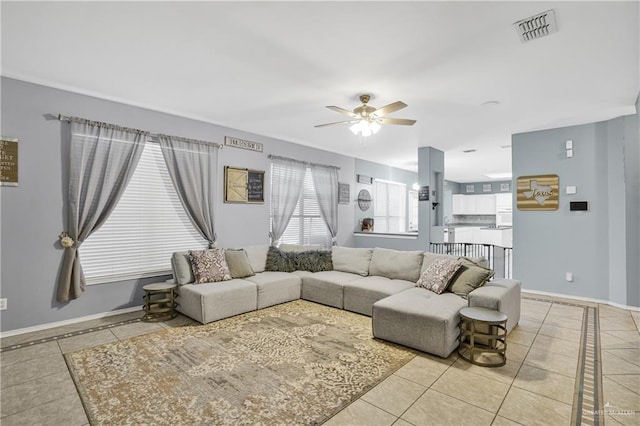 tiled living room with ceiling fan