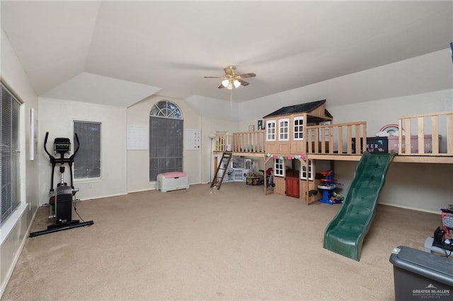 interior space with carpet, vaulted ceiling, and ceiling fan