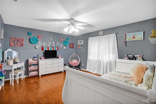 bedroom featuring hardwood / wood-style floors and ceiling fan