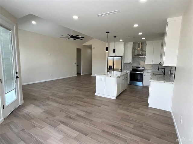 3503 Emma Dr, Weslaco, TX 78596 - kitchen with stainless steel appliances, wall chimney exhaust hood, open floor plan, recessed lighting, and a center island