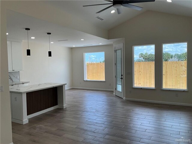 3503 Emma Dr, Weslaco, TX 78596 - kitchen with ceiling fan, open floor plan, dark wood-style flooring, white cabinets, and pendant lighting