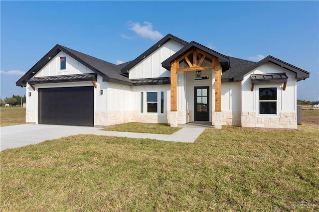 modern inspired farmhouse with concrete driveway, a front lawn, a standing seam roof, and board and batten siding